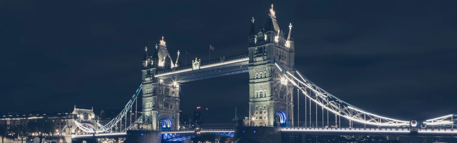 Tower Bridge in London illuminated against a dark night sky.