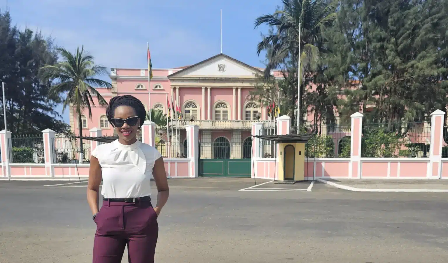 Angela Blair Cadet standing in front of the Presidential Palace in São Tomé and Príncipe.