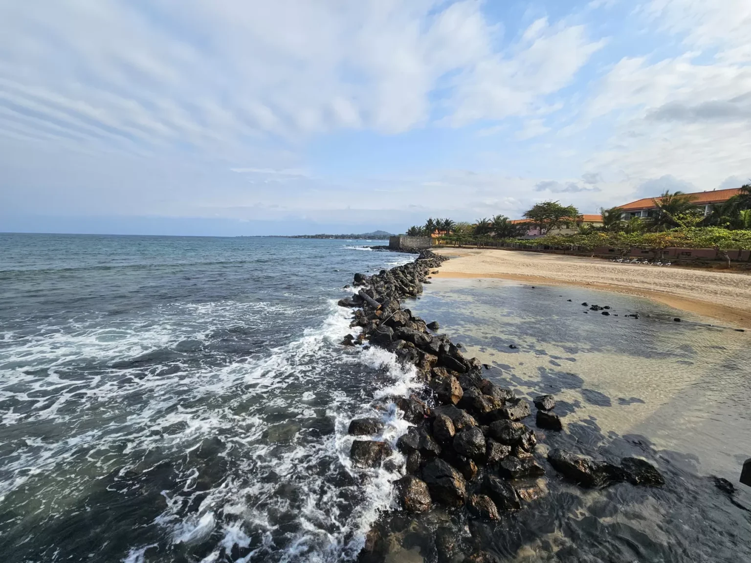 Beautiful tropical beach in São Tomé and Príncipe with palm trees and ocean view.
